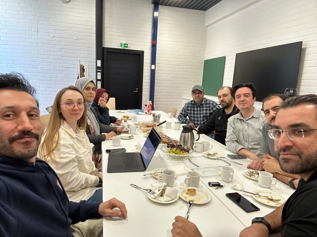 WeCode board members and community gathering around a breakfast table